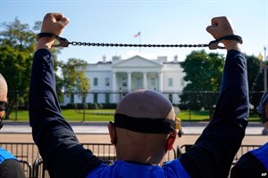  A member of the Uyghur American Association rallies in front of the White House