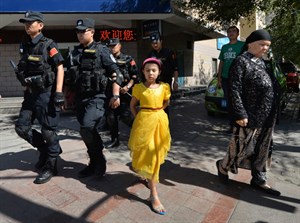 Chinese police patrol the streets of the Muslim Uighur quarter in Urumqi